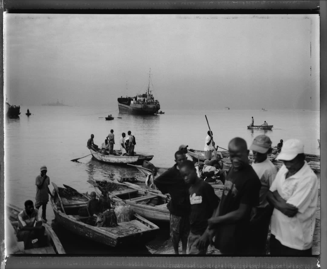 Outside of the main harbor in Port-au-Prince thousands of Haitian refugees try to flee the country by boats. Waiting for d...