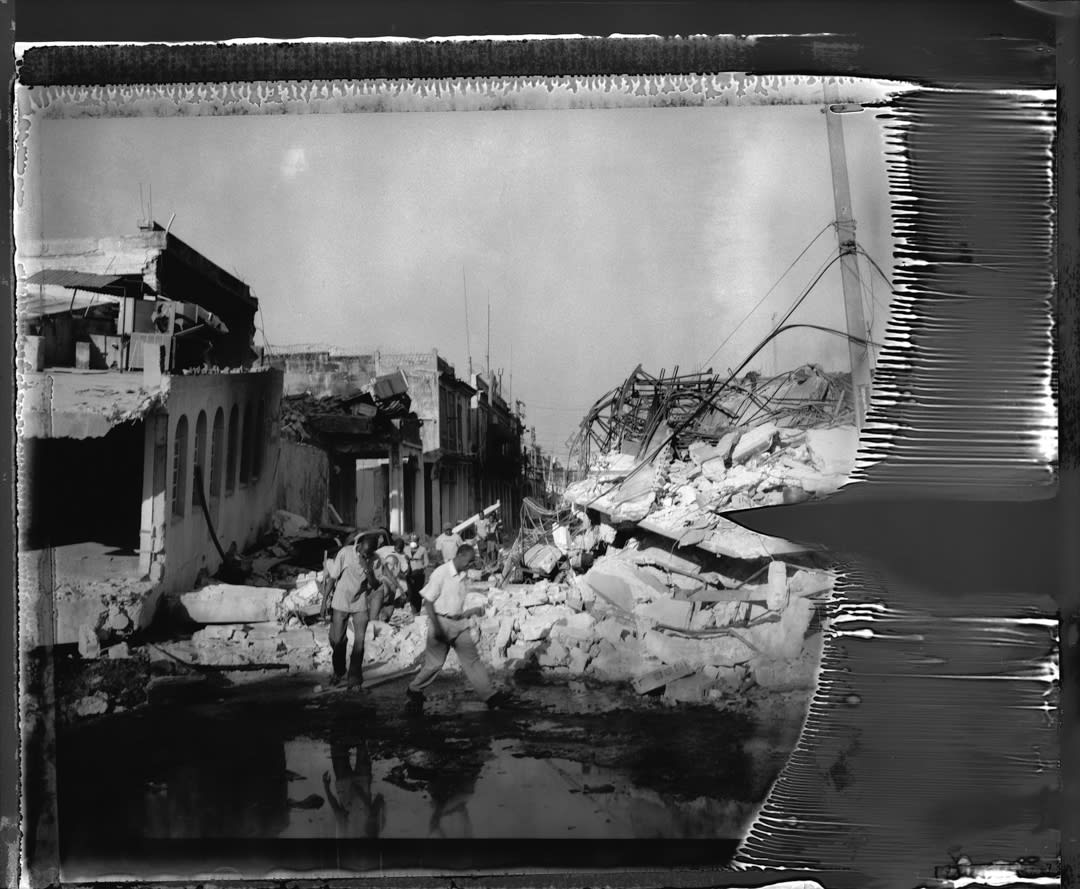 People moving through the rubble of downtown Port Au Prince.