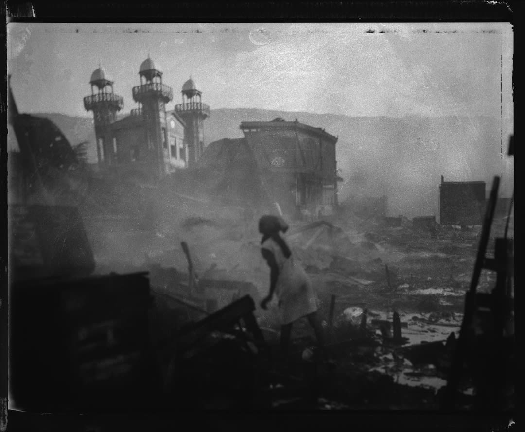 A woman tries to put out a fire that consumed a large portion of the central market in downtown Port au Prince. 
