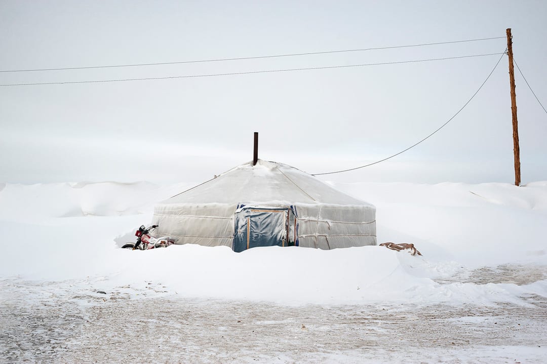 Mongolia. Arkhangay Province. An abandoned yurt lies buried under snow near the Tsamba family’s home, left behind after an...