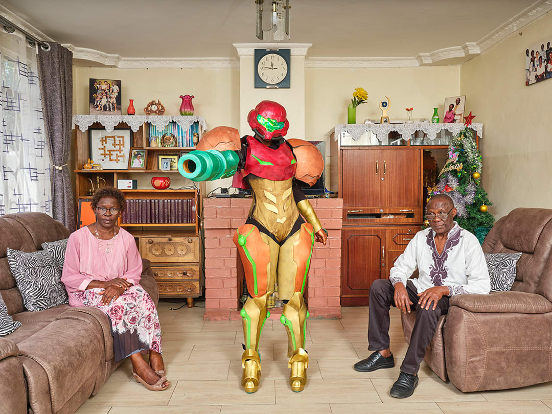Jess (27),  poses with her parents in their living room in Nairobi (Kenya); she works as a designer and has been practicin...