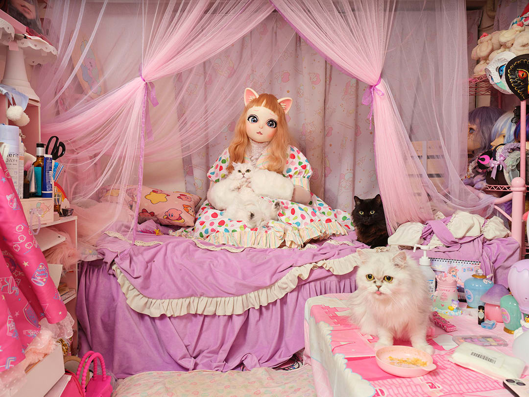 15/05/2024 
Pitan (33) with her three cats in her Tokyo bedroom. 
A costume designer for young entertainment artists, in t...