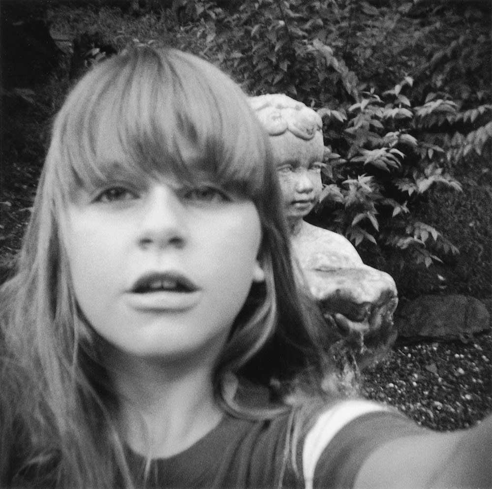 I took a picture of myself with the statue in the backyard. Photograph by Janet Stallard in collaboration with Wendy Ewald.