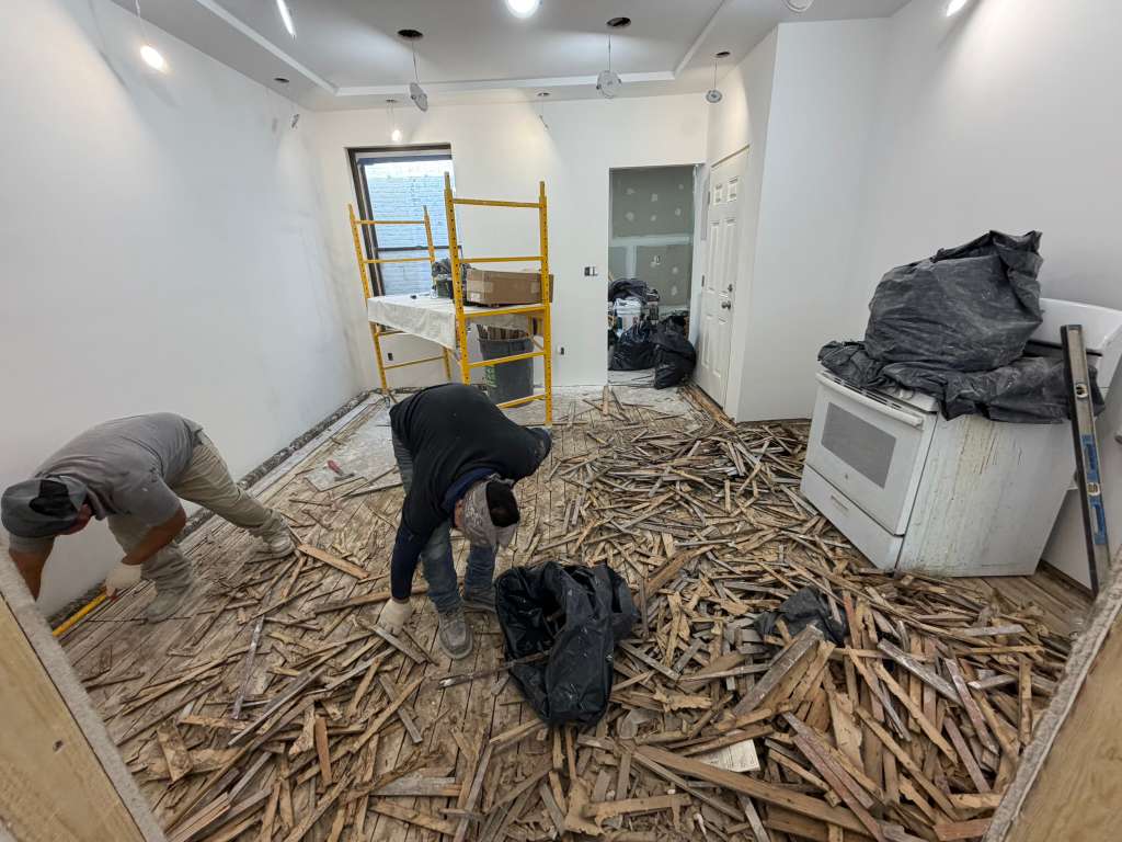 Fibinachi Construction crew performing gut renovation flooring work