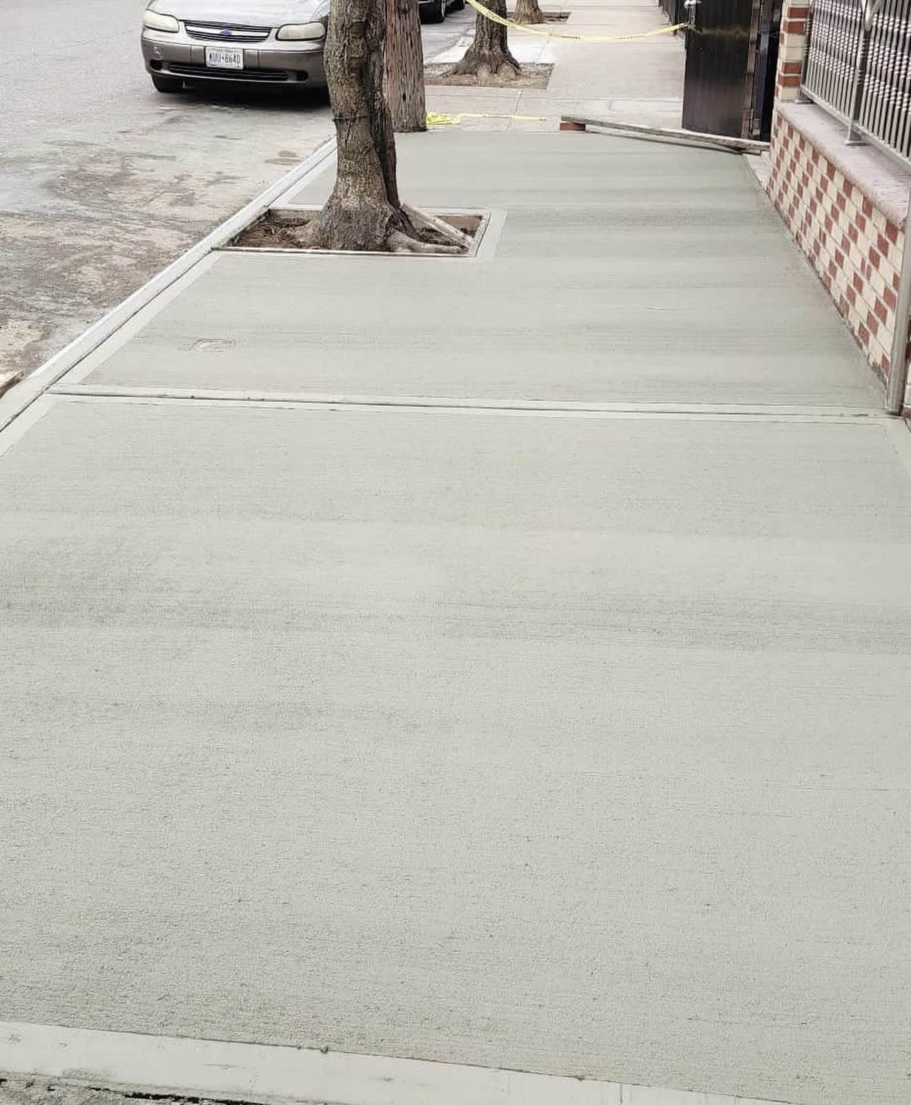 Fresh concrete sidewalk replacement Brooklyn by Fibinachi Construction