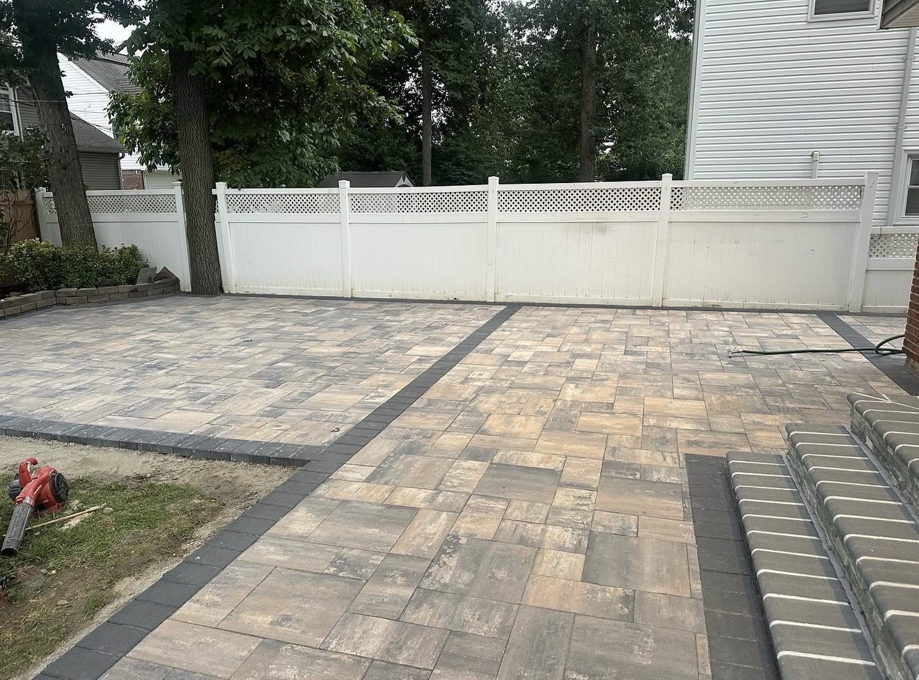 Two-tone paver patio backyard installation by Fibinachi Construction