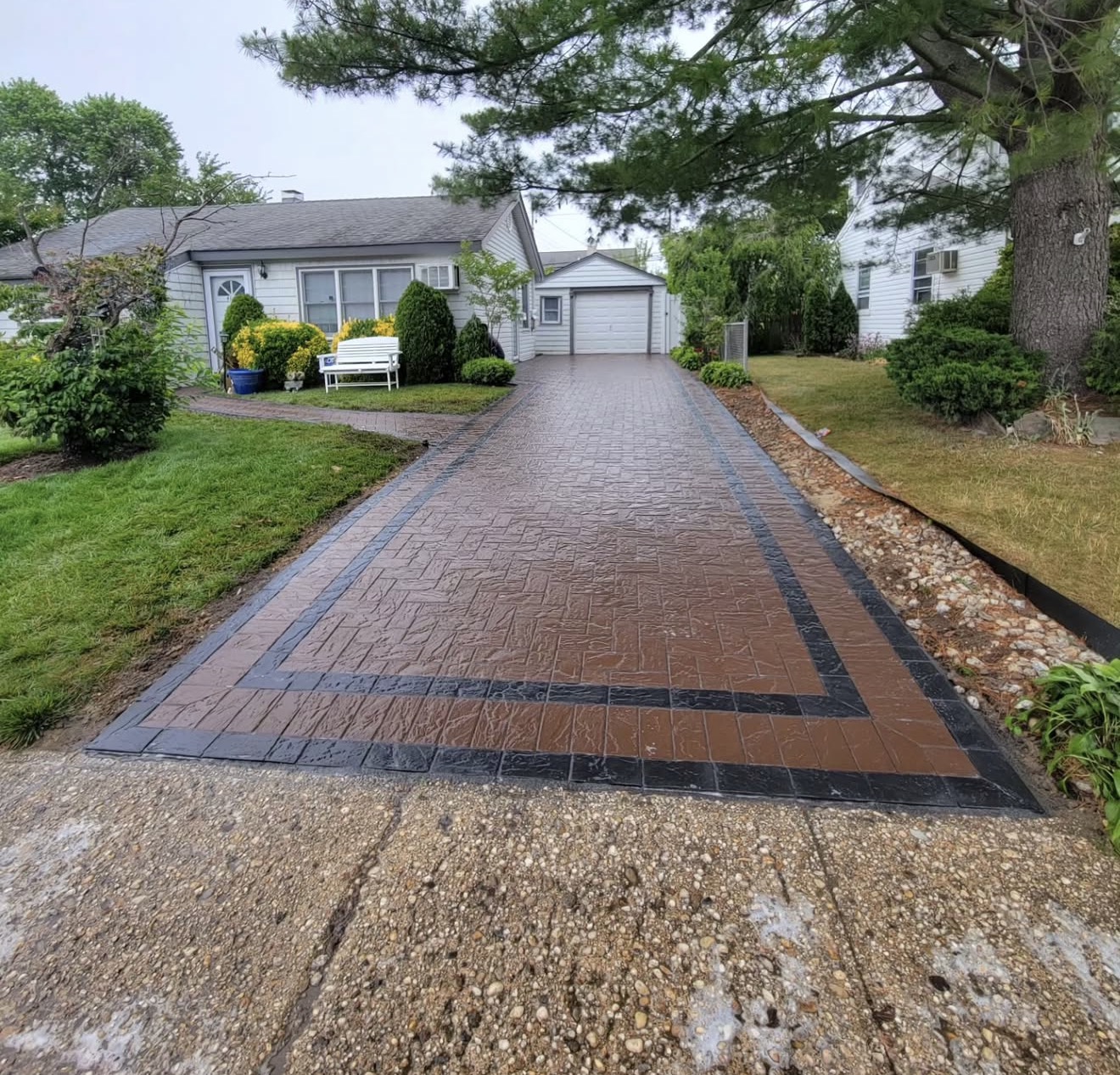 Stamped concrete driveway with paver border Long Island by Fibinachi Construction