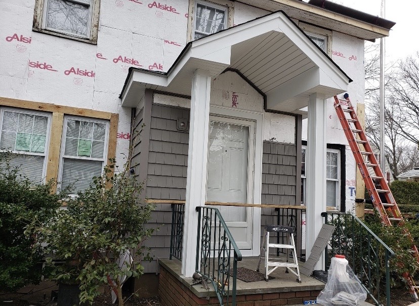 New siding installation with porch by Fibinachi Construction Long Island