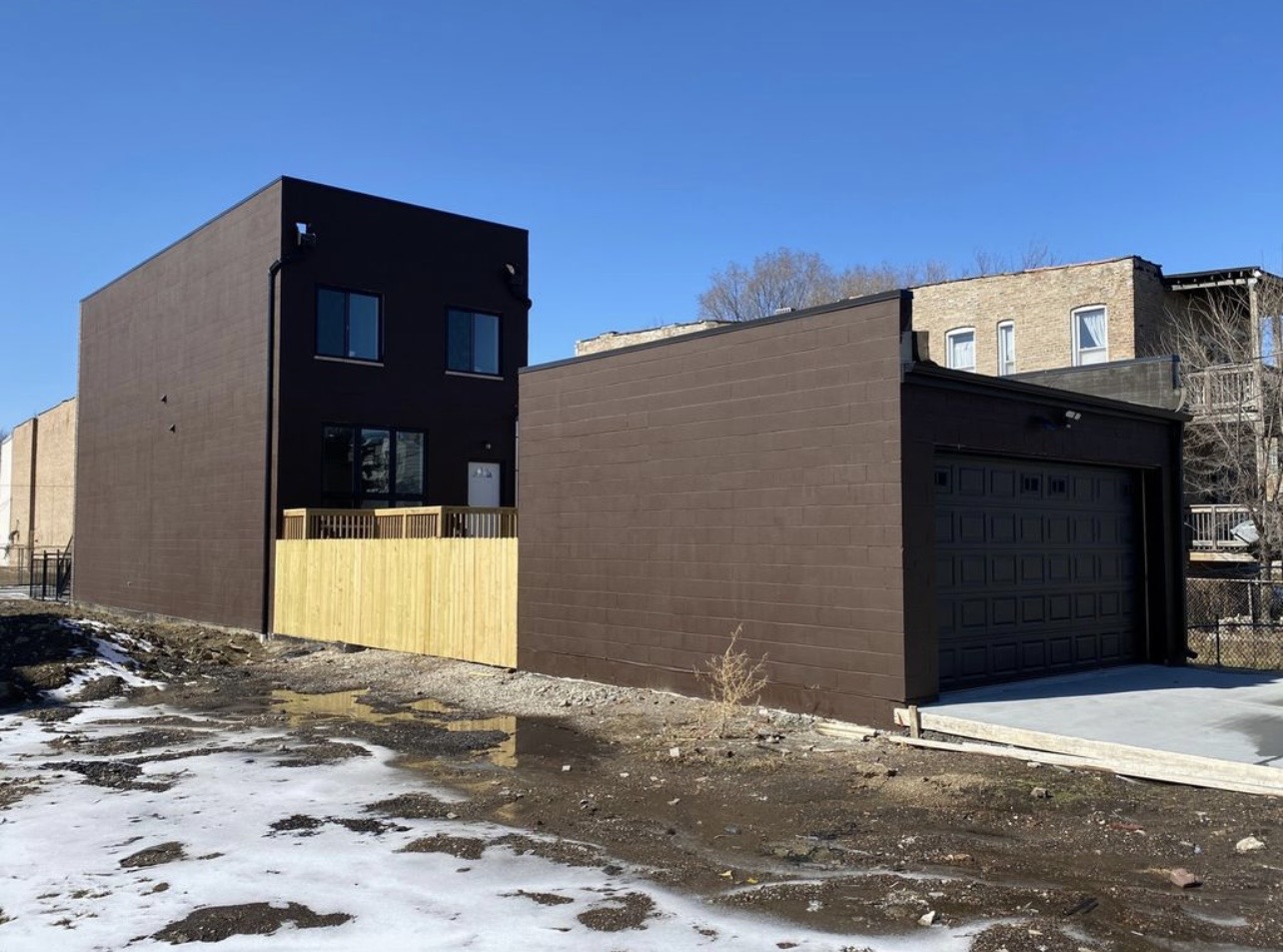 Dark stucco new construction commercial building by Fibinachi Construction