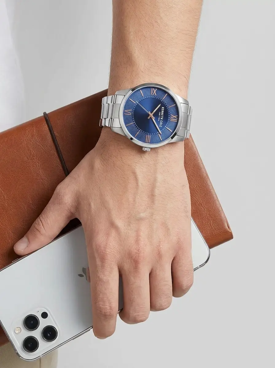 Elegant Kenneth Cole Modern Classic watch in polished silver stainless steel, featuring a textured outer ring and smooth sunray center dial