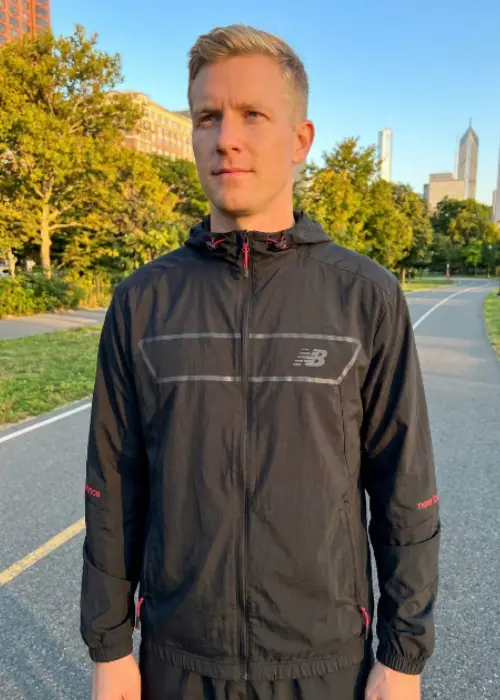Men's New Balance Vision Pack full-zip lightweight polyester jacket in black and red chevron stripe