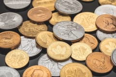 A detailed view of various gold and silver coins, ideal for financial themes.