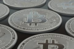 Detailed close-up of silver Bitcoin coins showcasing digital currency concepts.