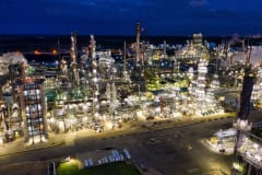 Dramatic aerial shot of an illuminated oil refinery at night in Rosemount, MN.