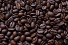 A detailed view of dark roasted coffee beans, ideal for rich and aromatic coffee brews.