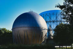 Gasometers in Pforzheim, Germany under a clear blue sky, showcasing industrial architecture.