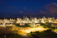 A stunning aerial shot of an illuminated oil refinery at night showcasing industrial production in Rosemount, MN.