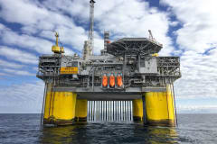 Majestic offshore oil platform in Norway's North Sea, under blue skies.