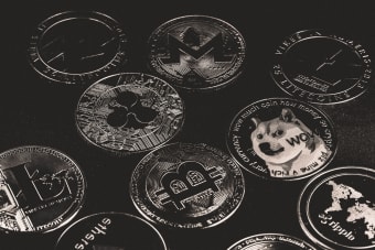 A collection of various cryptocurrency coins including Bitcoin, Ethereum, and Dogecoin.