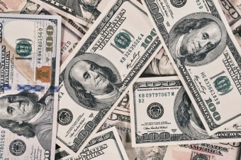 Detailed close-up of US dollar bills highlighting wealth and finance concepts.