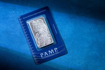 High-quality silver PAMP bar on a striking blue background, emphasizing luxury and security.