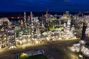 Dramatic aerial shot of an illuminated oil refinery at night in Rosemount, MN.