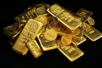 A collection of shining gold bars and coins symbolizing wealth and investment.