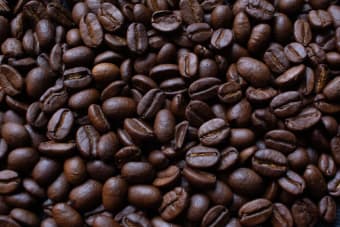 A detailed view of dark roasted coffee beans, ideal for rich and aromatic coffee brews.