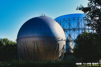 Gasometers in Pforzheim, Germany under a clear blue sky, showcasing industrial architecture.