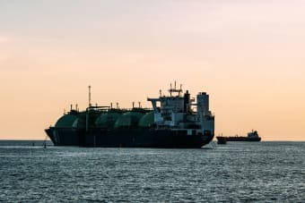 A large LNG tanker ship on the ocean at sunset, capturing the tranquil beauty of maritime industry.