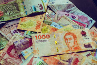 A vibrant collection of Argentine peso banknotes showcasing diverse designs and denominations.