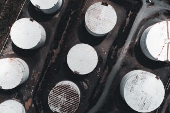 Drone shot showcasing large industrial storage tanks from above.