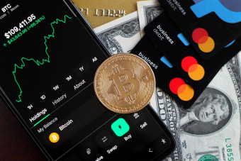 A visual representation of Bitcoin trading and financial transactions with credit cards and cash.