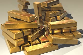 A pile of lustrous gold bars symbolizing wealth and prosperity.