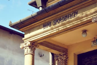 Detailed view of a historic Polish bank facade with classic architectural columns.