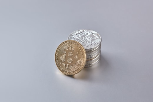 Stack of Bitcoin and cryptocurrency coins representing digital currency and financial wealth.