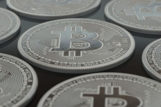 Detailed close-up of silver Bitcoin coins showcasing digital currency concepts.