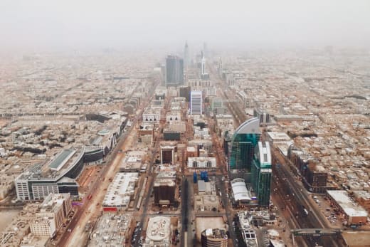 Aerial photograph of Riyadh's modern cityscape with iconic skyscrapers and bustling streets.