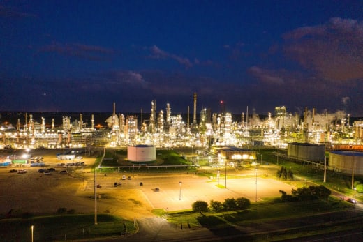 A stunning aerial shot of an illuminated oil refinery at night showcasing industrial production in Rosemount, MN.