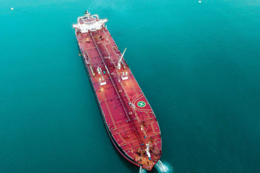 Aerial shot of an oil tanker cruising through the ocean, emphasizing maritime transport.