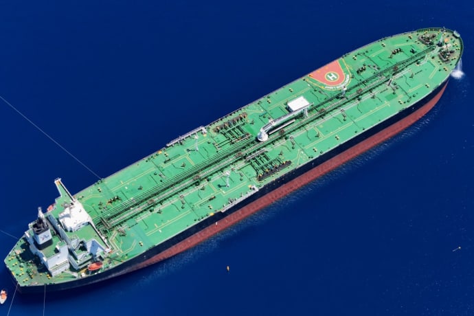 Aerial shot of an oil tanker sailing in the ocean near Vado Ligure, Italy.