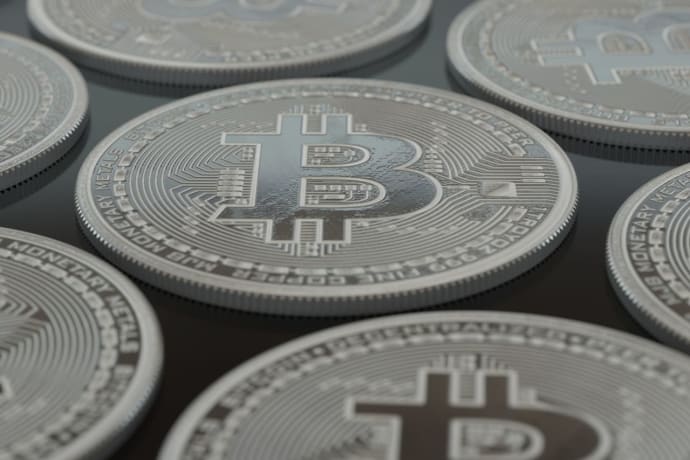 Detailed close-up of silver Bitcoin coins showcasing digital currency concepts.
