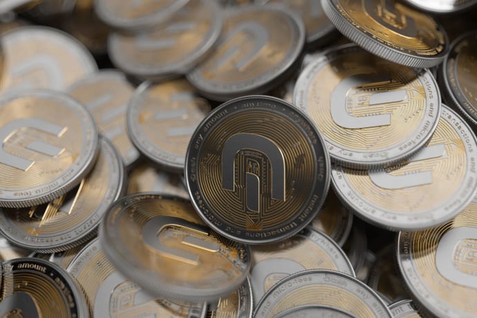 Close-up of multiple gold and silver cryptocurrency coins symbolizing digital currency and finance.