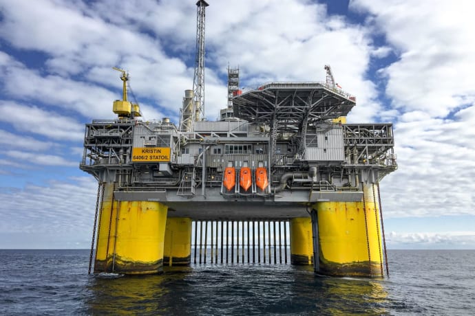 Majestic offshore oil platform in Norway's North Sea, under blue skies.