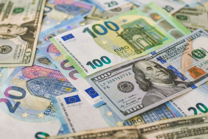 A detailed image of Euro and US dollar banknotes scattered, symbolizing global currency exchange.