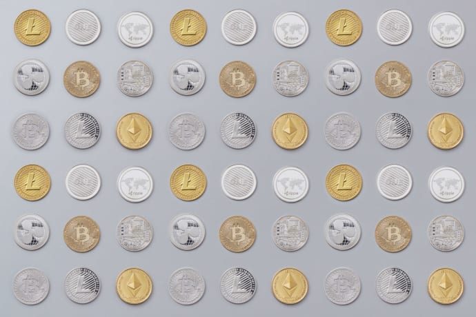A seamless pattern of various cryptocurrency coins in gold and silver tones.