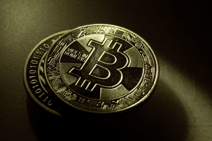 Detailed shot of a Bitcoin coin with a digital texture highlighting its cryptocurrency design.