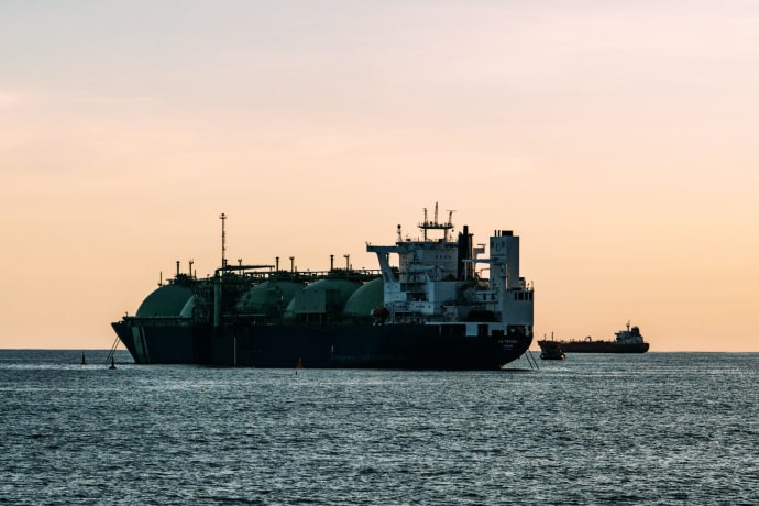 A large LNG tanker ship on the ocean at sunset, capturing the tranquil beauty of maritime industry.