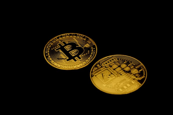 Golden Bitcoin cryptocurrency coins on a dark background symbolizing digital finance and investment.
