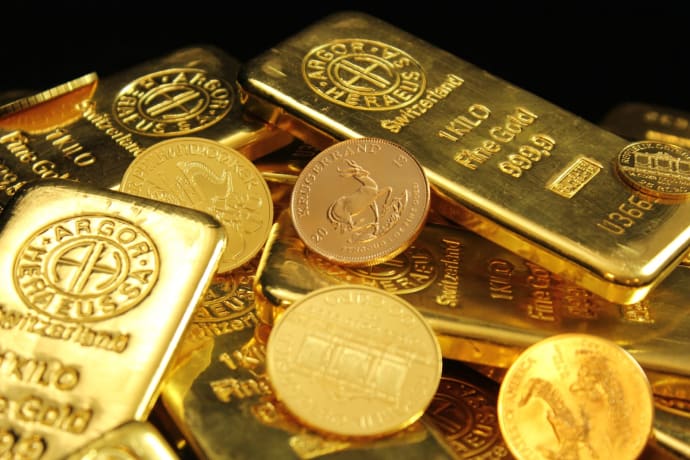 A detailed image of gold bars and coins symbolizing wealth and financial investment.